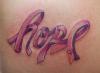 a tattoo of hope and pink ribbon