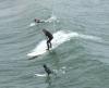 Three surfers in Huntington Beach
